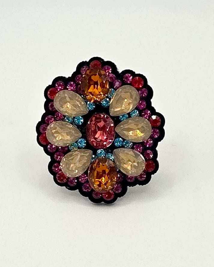Multicolored gemstone ring on a white background