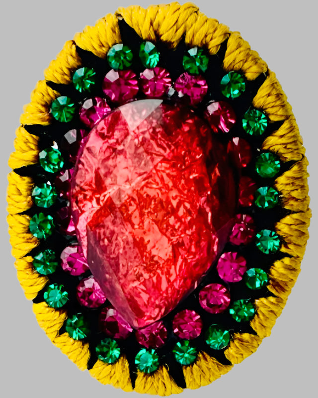 A pair of colorful earrings featuring a red central gem surrounded by green and yellow accents