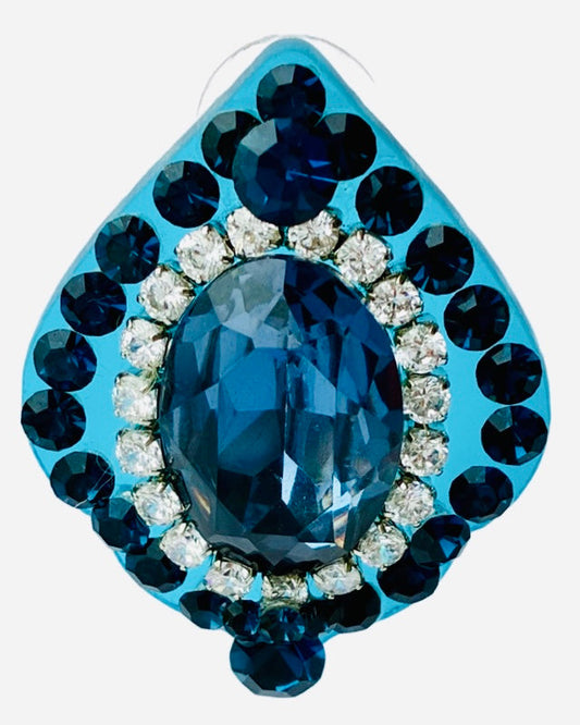 A blue-colored decorative eye-shaped accessory with a large central blue gem surrounded by smaller blue and clear gems.