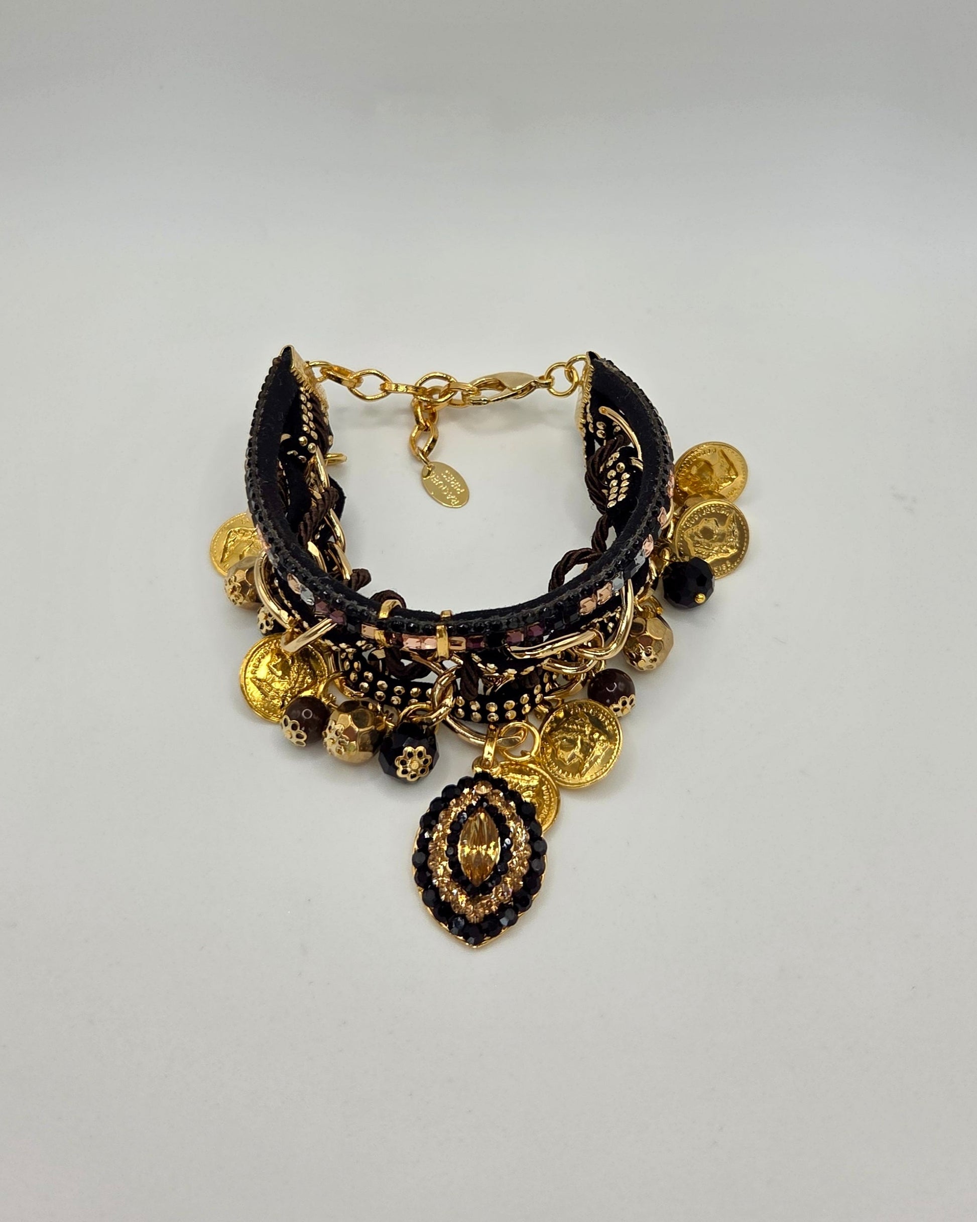 Black and gold bracelet on a light gray background