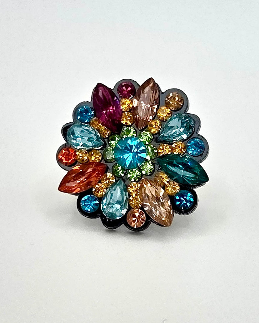 Multicolored gemstone ring on a white background