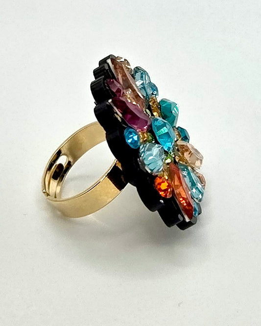 Ring with multicolored gemstones on a white background