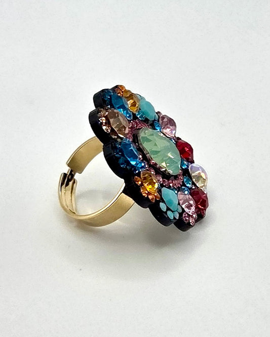 Ring with multicolored gemstones on a white background