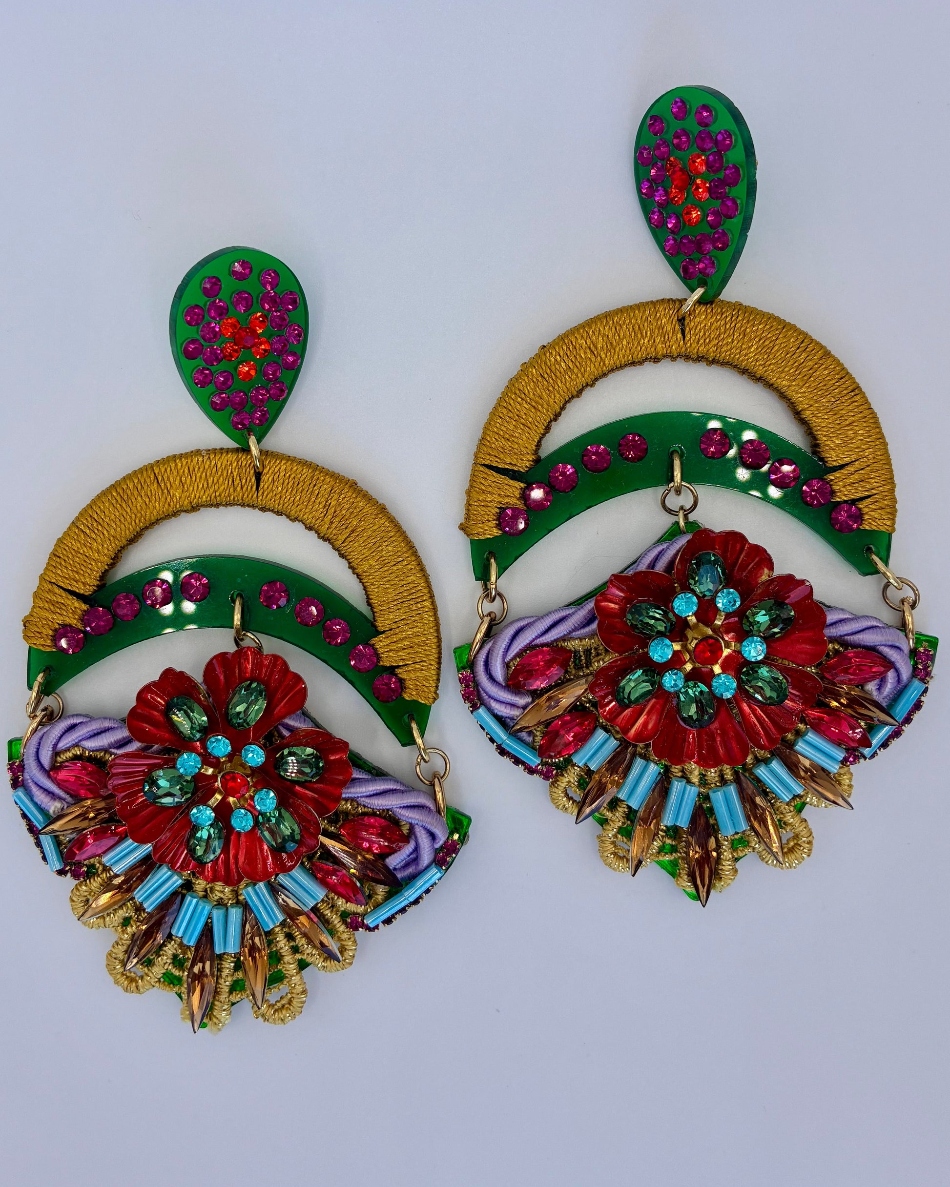 Colorful earrings with floral designs on a white background