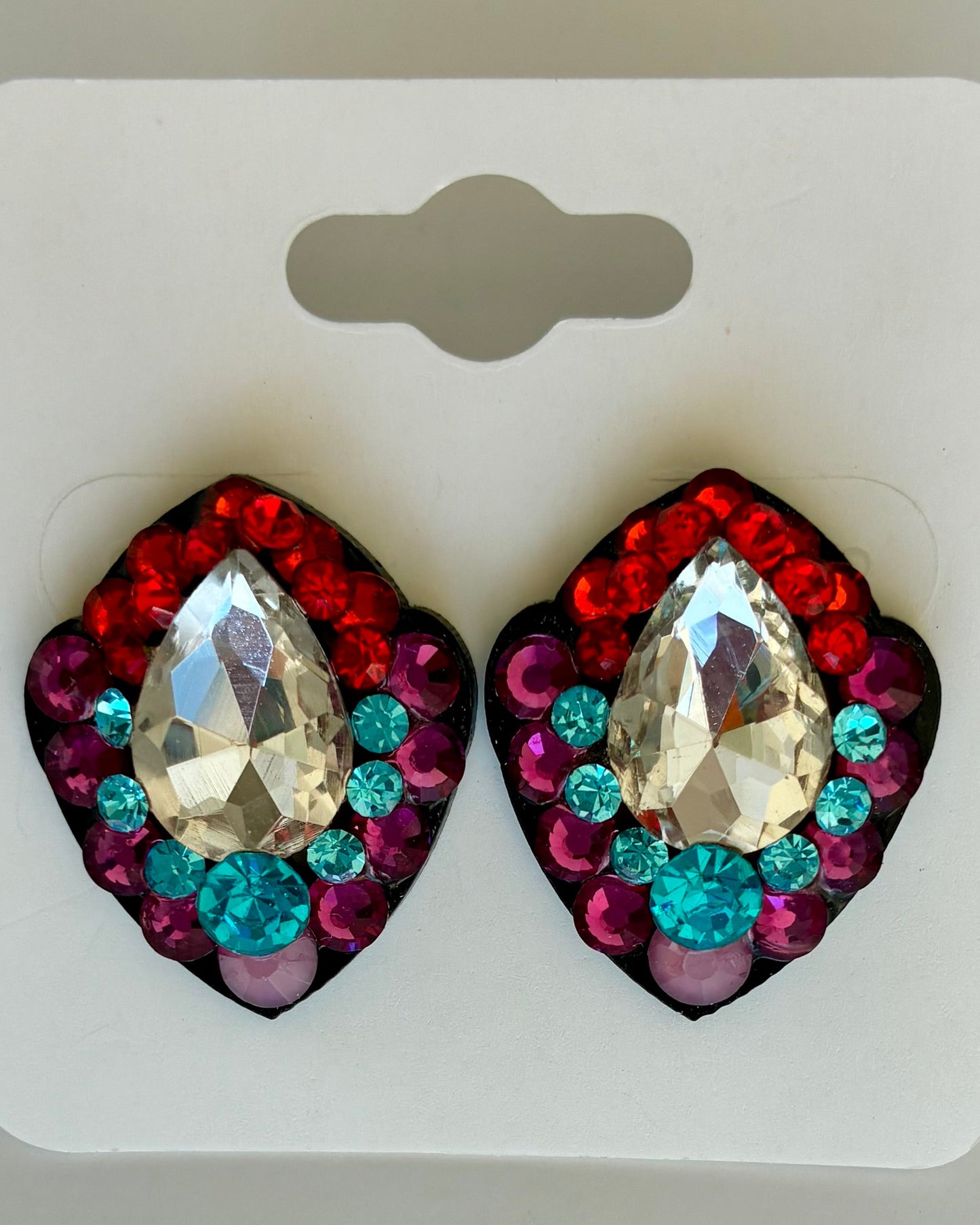 Multicolored gemstone earrings on a white card